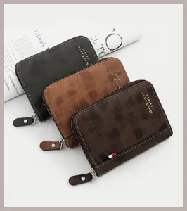 Detail of three textured leather men's wallets in black, brown, and coffee with gold stamp.