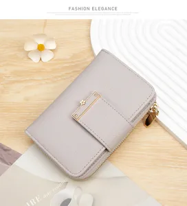 Close-up of a lilac litchi grain leather wallet with elegant gold flower clasp