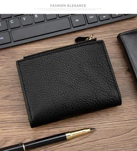 Close-up detail of black pebble grain leather wallet with a premium texture and gold zipper