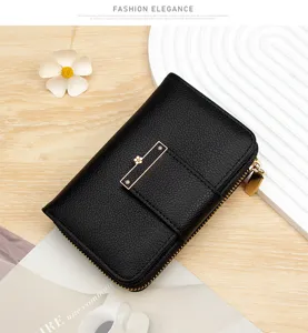 Close-up of black litchi grain leather wallet with elegant gold floral buckle