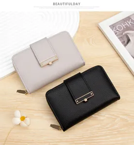 Detailed view of women's short leather wallets in black and grey with lychee texture