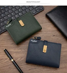 Detailed view of two women's short wallets in green and blue with lychee leather texture.