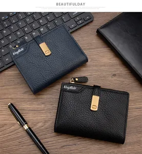 Detail view of lychee pattern leather wallets with zipper and buckle closure.