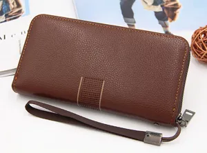 Macro view of a brown pebbled leather long wallet for men with a durable wrist strap.