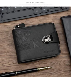 Close-up of black men's wallet with metal buckle on a wooden desk with pen and keyboard.