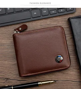 Close-up of men's brown zip-around wallet with brushed leather texture on a desk