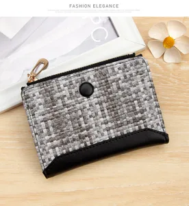 Close-up of woven grey and white small wallet with black leather trim