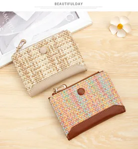 Detailed view of women's woven short wallets with zipper and snap button