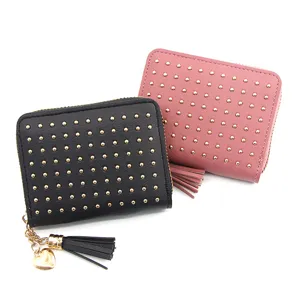 Detailed view of women's faux leather wallets with gold studs and heart tassel