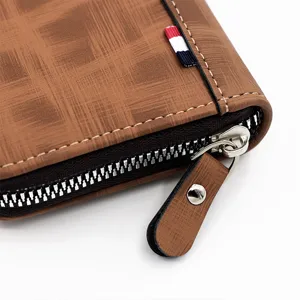 Detailed macro shot of brown textured leather men's zipper wallet with elegant stitching