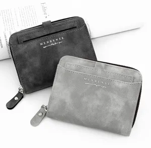 Close-up detail view of two men's matte short wallets in grey tones with zipper