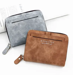 Macro view of frosted brown and grey men's zip wallets on white background.