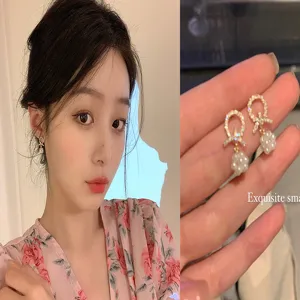 Exquisite sparkling bow-knot earrings with pearl drops shown on model and detail view