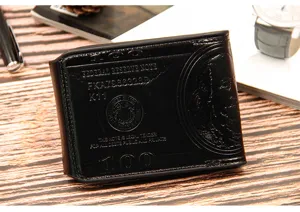 Detailed close-up of a black men's wallet with embossed US 100 dollar bill design texture
