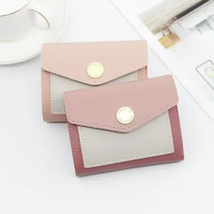 Detailed view of stylish trifold women wallets with gold snap buttons and contrast stitching
