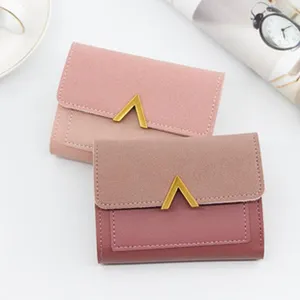 Close-up of stylish minimalist trifold wallets for women in dusty pink and light pink hues