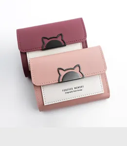 Detail showing two compact tri-fold women's wallets with cute cat ear metal clasps.