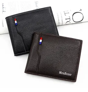 Macro view of two pebbled PU leather wallets in black and brown with logo detail.