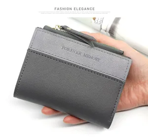 Détails d'un portefeuille bicolore gris mat pour femme avec fermeture éclair.
