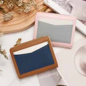 Color-block women's short wallet with multi-slot card holder and zipper closure.