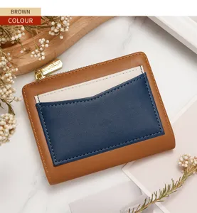 Close-up of color-block women's short wallet with brown, navy and cream leather