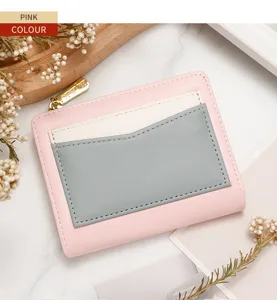 Close-up of stylish pink and grey color-block women's short zipper wallet with gold hardware