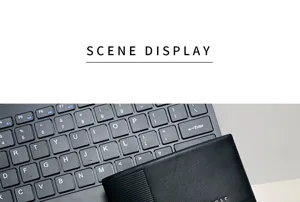 Macro view of a minimalist black men's wallet on a laptop keyboard.
