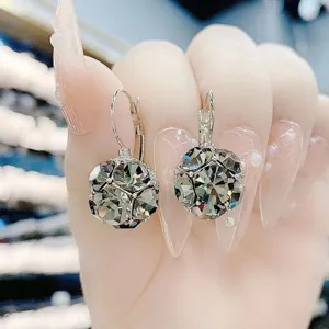Close-up of elegant grey faceted crystal ball earrings with French hooks