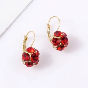 Elegant gold plated earrings featuring sparkling red crystal spheres in French style