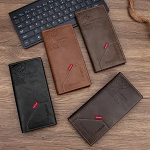 Detailed view of four elegant colors of men's PU leather long wallets on a vintage wooden desk