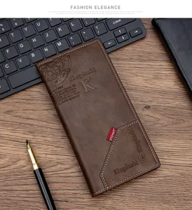 Detail view of a stylish long brown PU leather men's wallet on a desk with office accessories