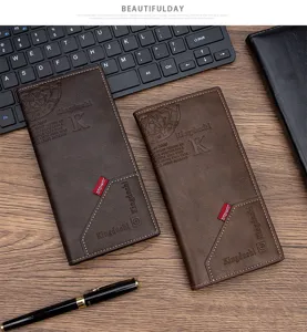 Detail view of slim PU leather men's long wallets with embossed branding on wood desk.