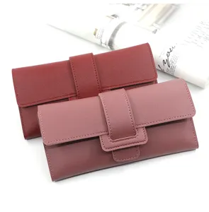 Close-up of stylish long tri-fold women's wallets in red and pink colors