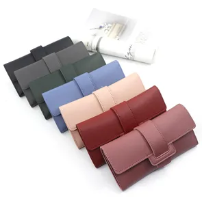 Detail view of stylish long tri-fold women's wallets with buckle straps in various colors