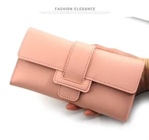 Detailed view of elegant pink tri-fold faux leather long wallet with buckle clasp closure