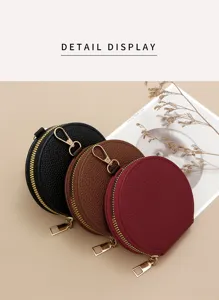 Macro view of three circular leather coin purses in black, brown, and wine red