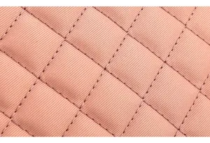 Macro detail showing the pink quilted ribbed fabric and stitching of the mommy bag
