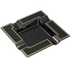 Detailed macro view of a large black square melamine cigar ashtray with gold line trim