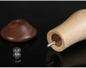 Detailed close-up view of the wooden pepper grinder parts showing grain and metal screw