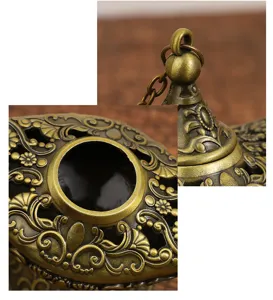 Close-up view of vintage bronze Aladdin lamp ornament showing detailed embossed floral scrollwork.