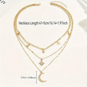 Close-up of a layered gold necklace featuring star and rhinestone moon pendants