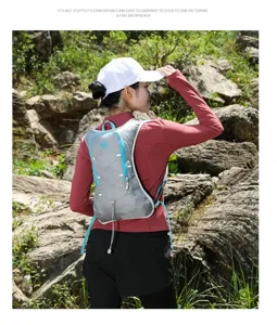 Back view of a lightweight grey and blue hydration running vest worn by a hiker outdoors