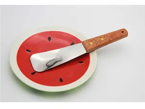 Professional stainless steel ice cream scraper with ergonomic wooden handle on plate