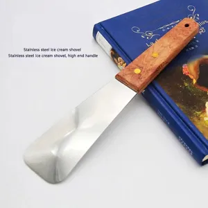 Close-up of a stainless steel ice cream shovel with a polished ergonomic wooden handle