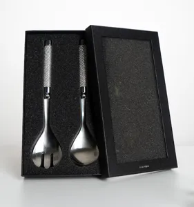 Detail of stainless steel salad server set with diamond texture handle in gift box