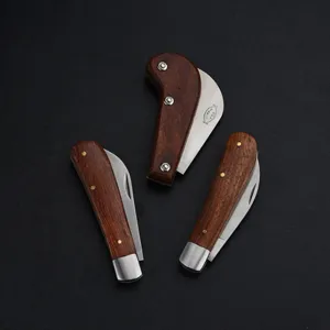 Detail view of folding garden knives with premium wooden handles and stainless steel blades