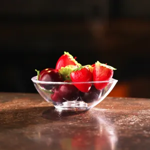 Detail shot of a transparent water-drop shaped PC salad bowl with artificial fruit