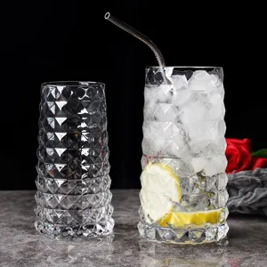 Detailed view of thick glass juice cups with a textured diamond pattern on black background