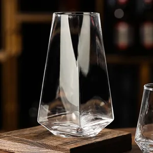 Macro view of a premium geometric clear glass cup with a hexagonal base on a wooden block