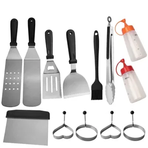 Stainless steel BBQ tool set including spatulas, tongs, brush, and squeeze bottles